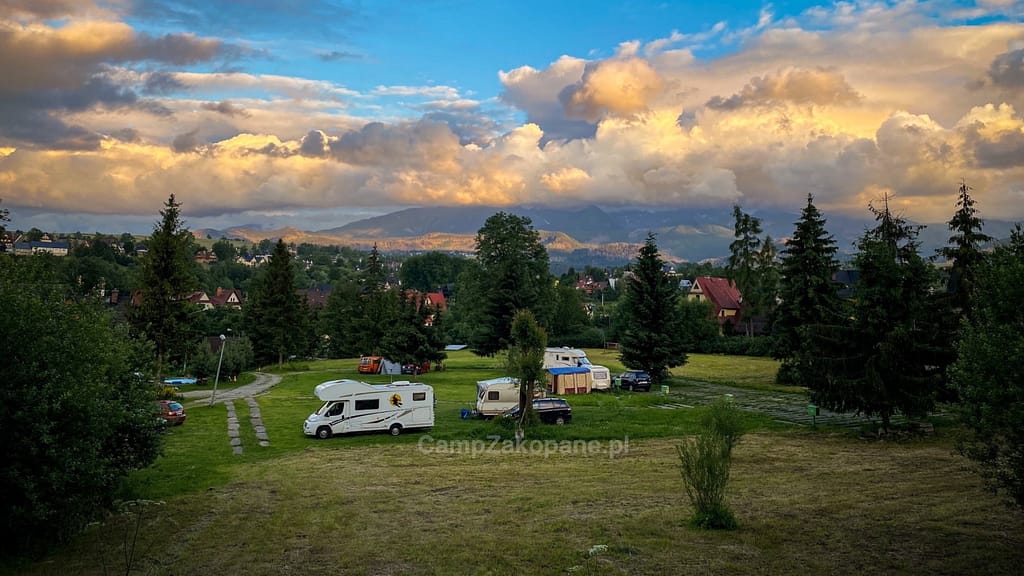 Przestronny teren kempingowy z kamperami i namiotami oraz widokiem na Tatry na Camping Harenda w Zakopanem